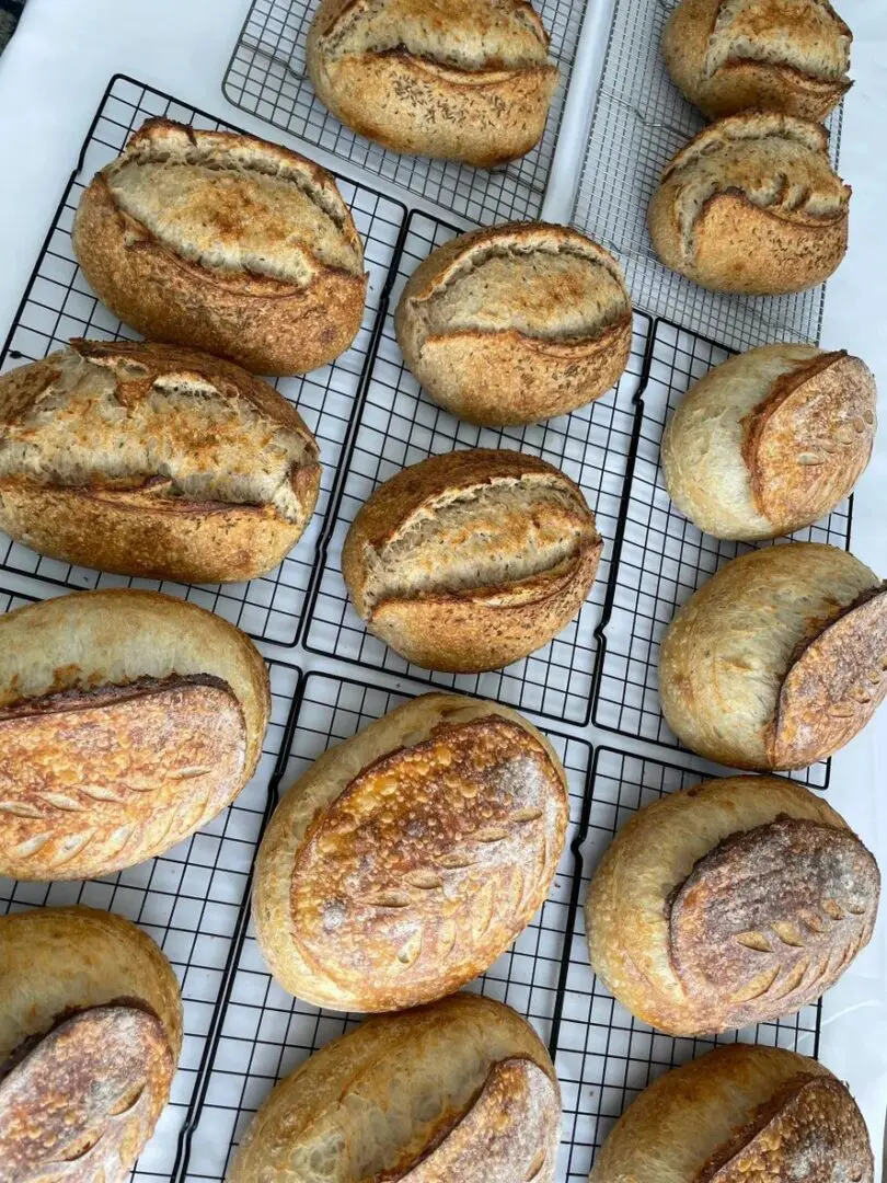 A bunch of bread sitting on top of a rack.