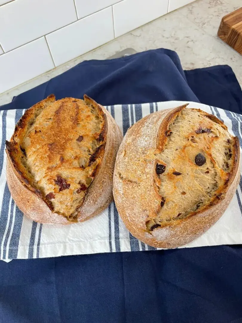 Two pieces of bread on a plate with blue and white towel.
