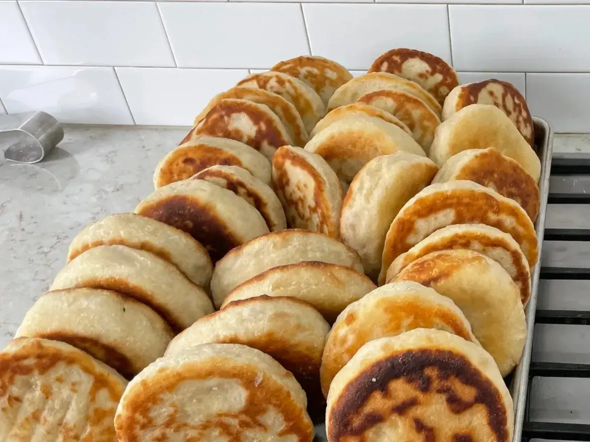 A pile of pancakes sitting on top of a table.
