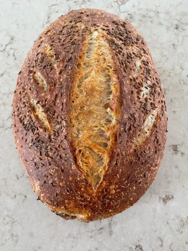 A loaf of bread with some type of brown stuff on it